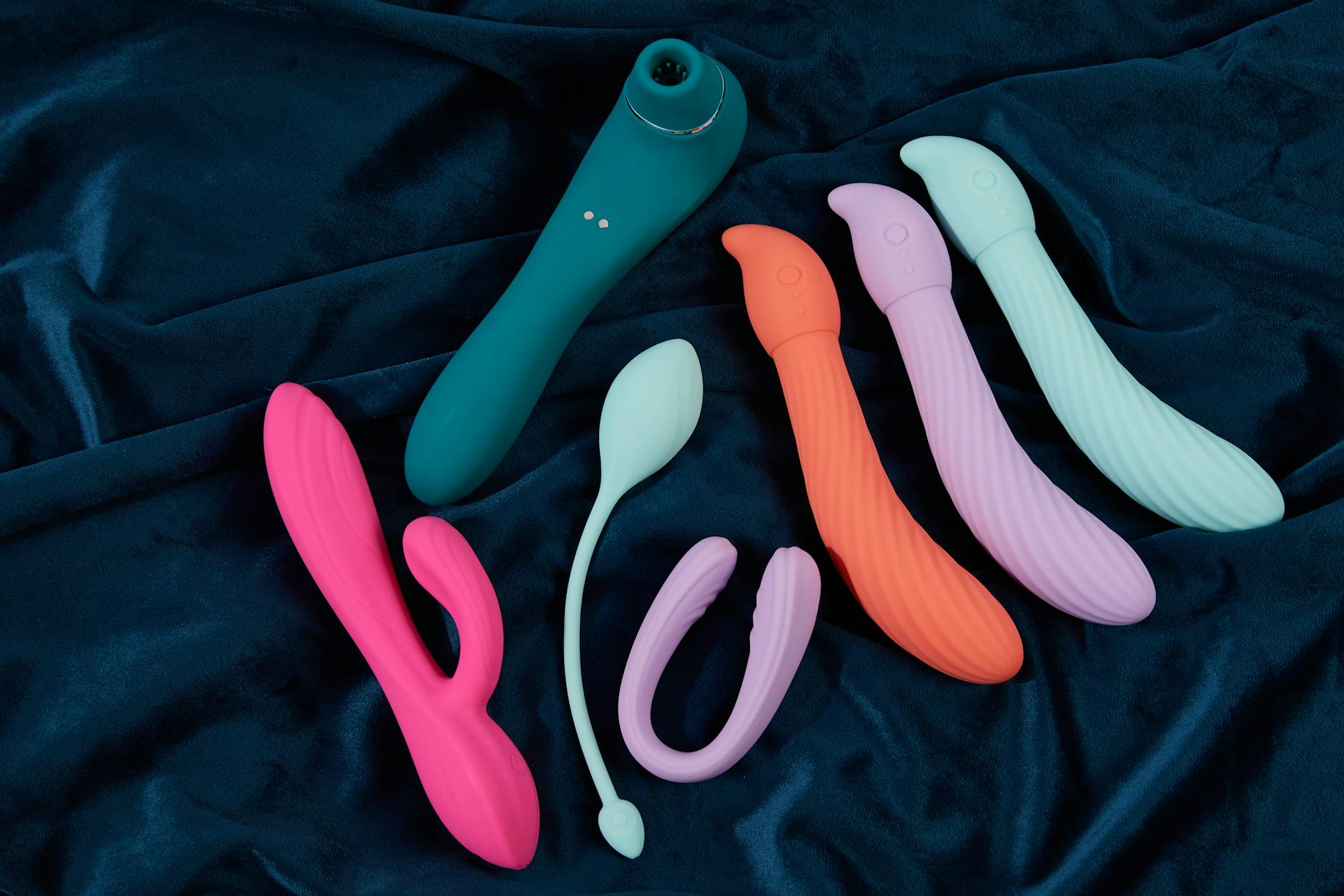 Pink vibrator on a purple background with heart confetti and candles
