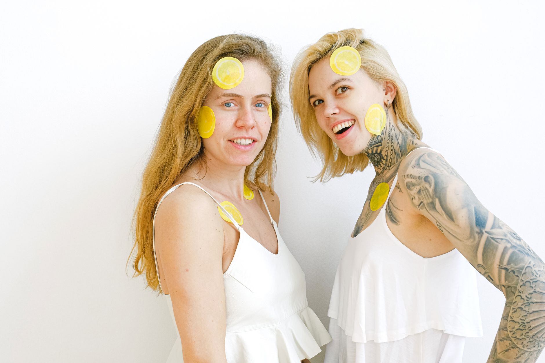 Bright yellow lemons arranged on a pastel green background, symbolizing curiosity and exploration