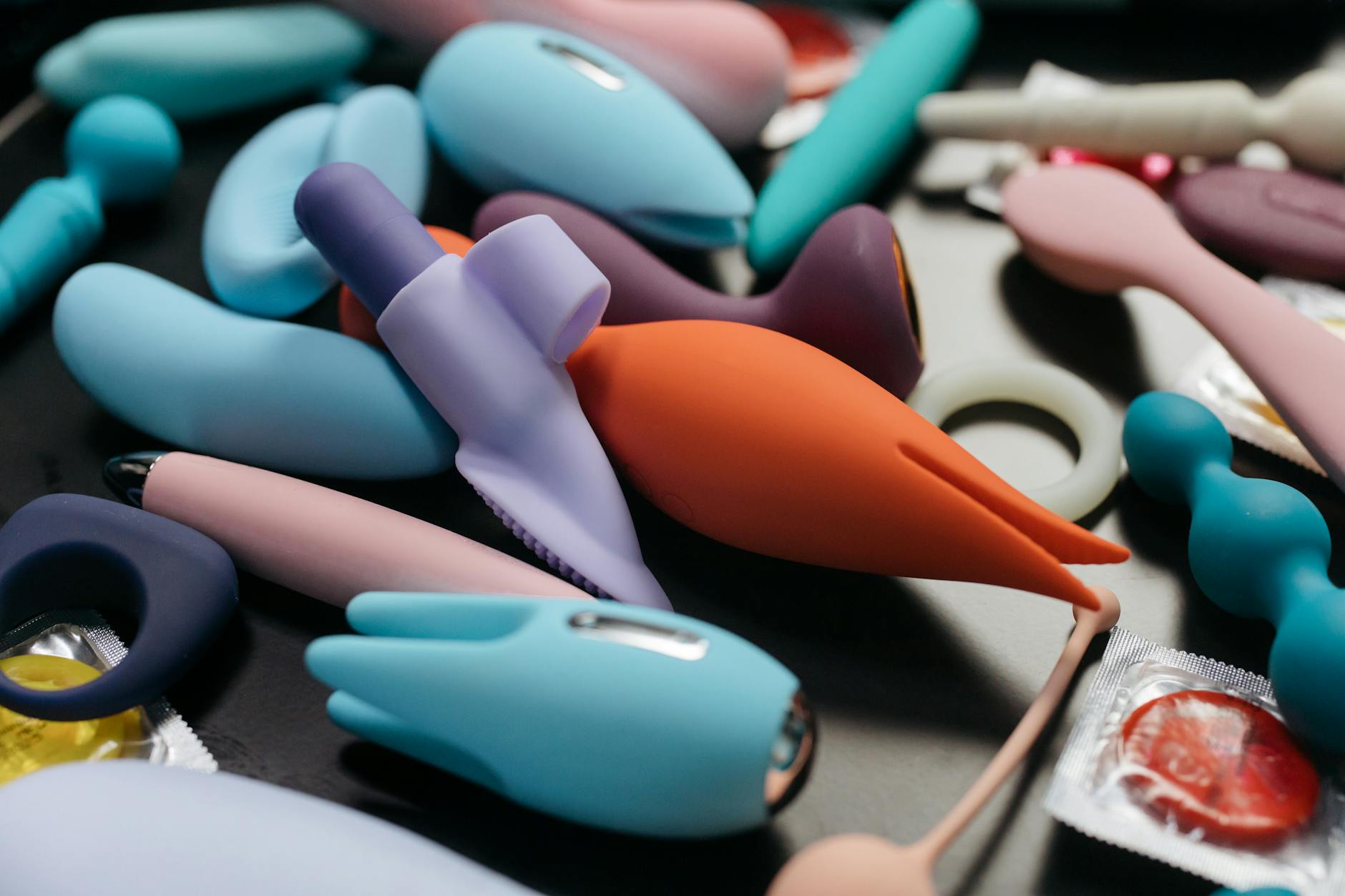 Close-up of colorful vibrators and adult toys arranged together