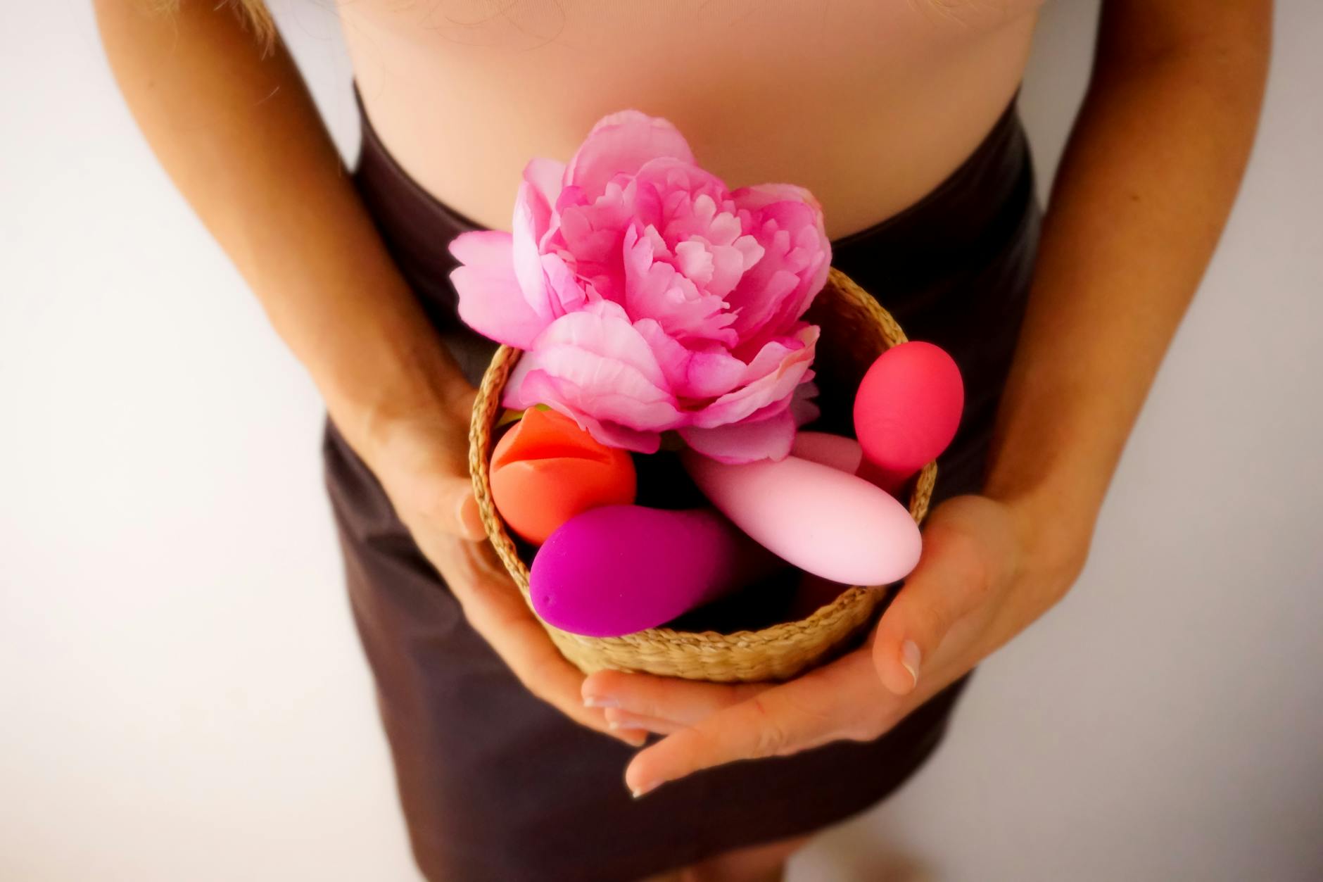 Pink vibrator on purple background with candles and hearts for romantic atmosphere